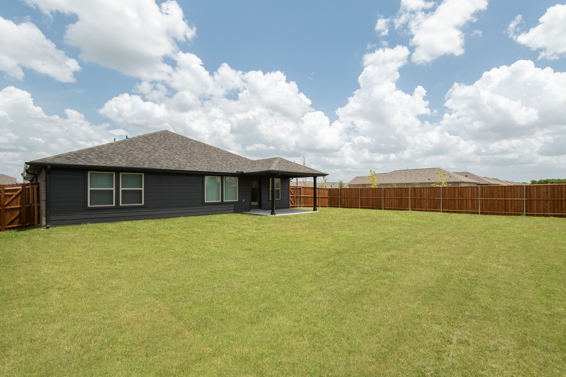 backyard with grass and covered patio