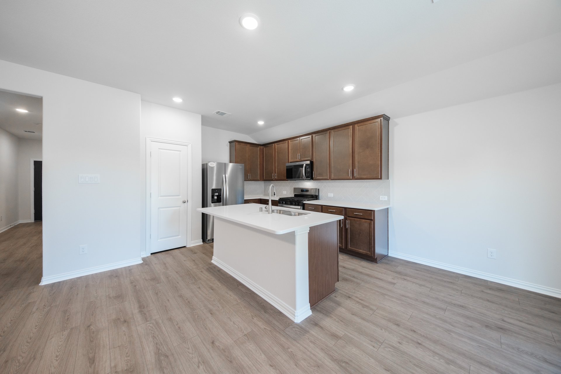 open kitchen with wood floors and island