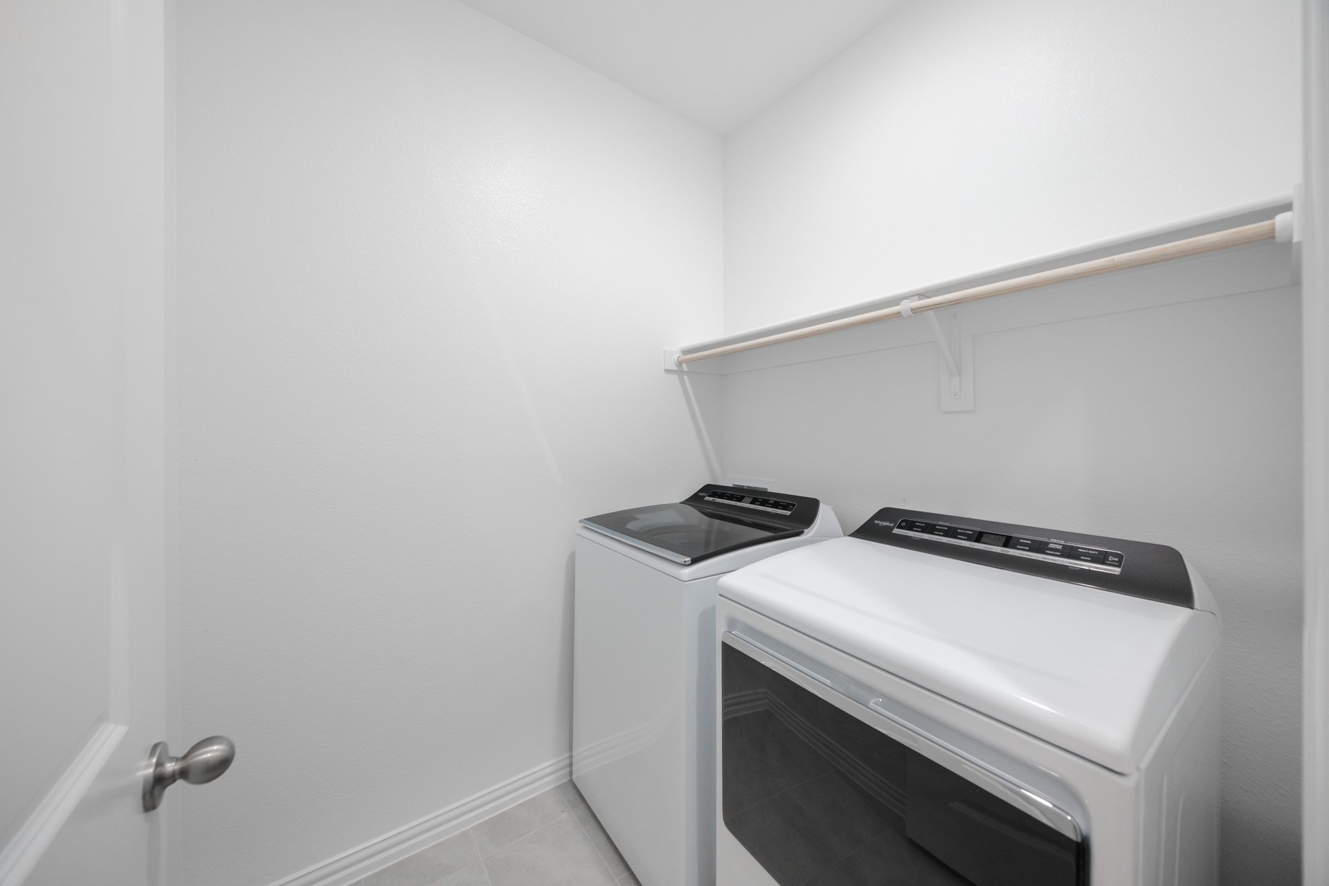 laundry room with tile floors, washer, and dryer