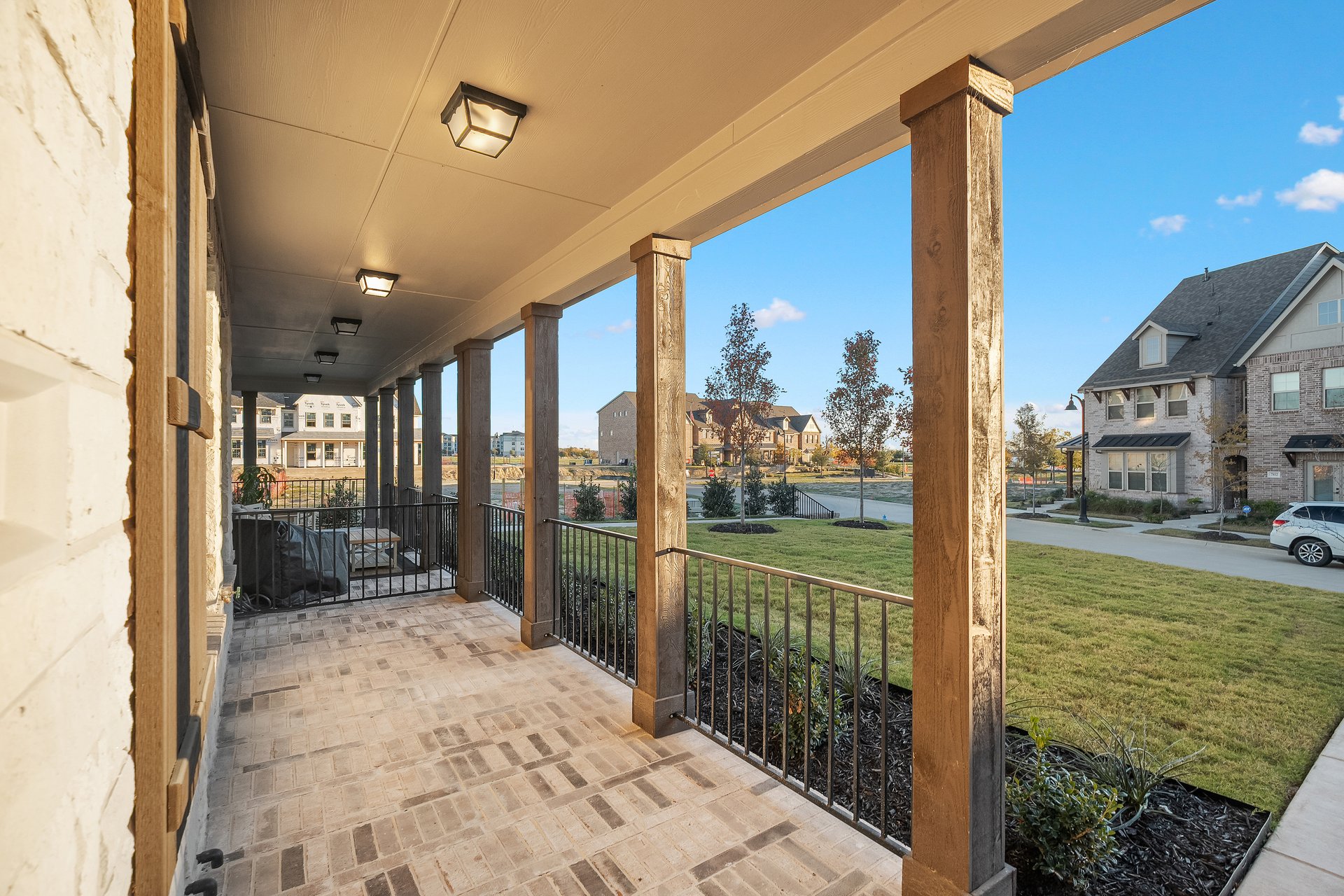 front porch with brick and landscaping