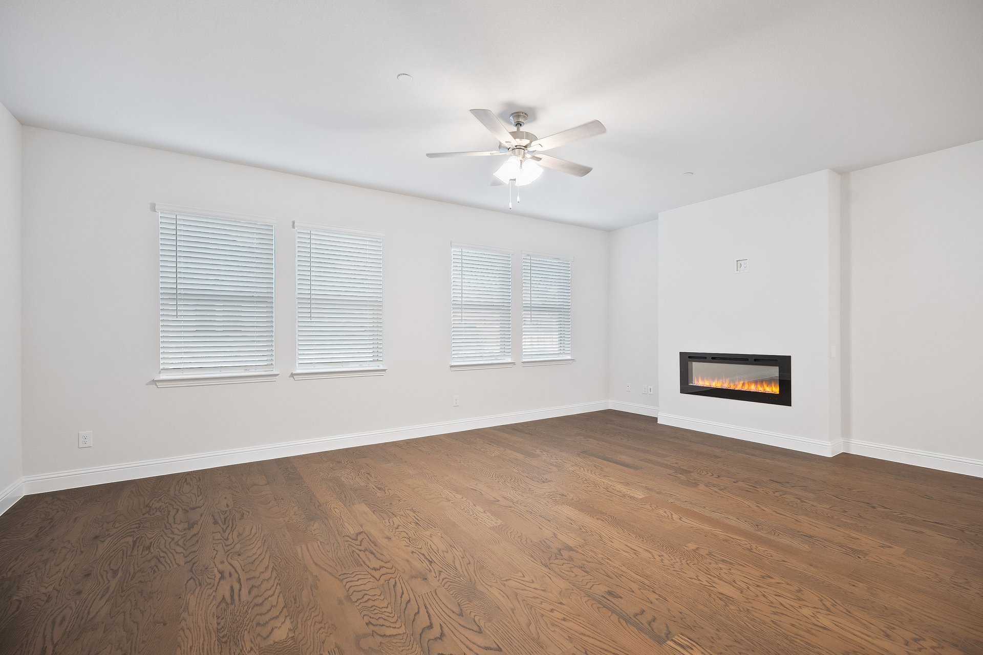 great room with wood flooring and fireplace