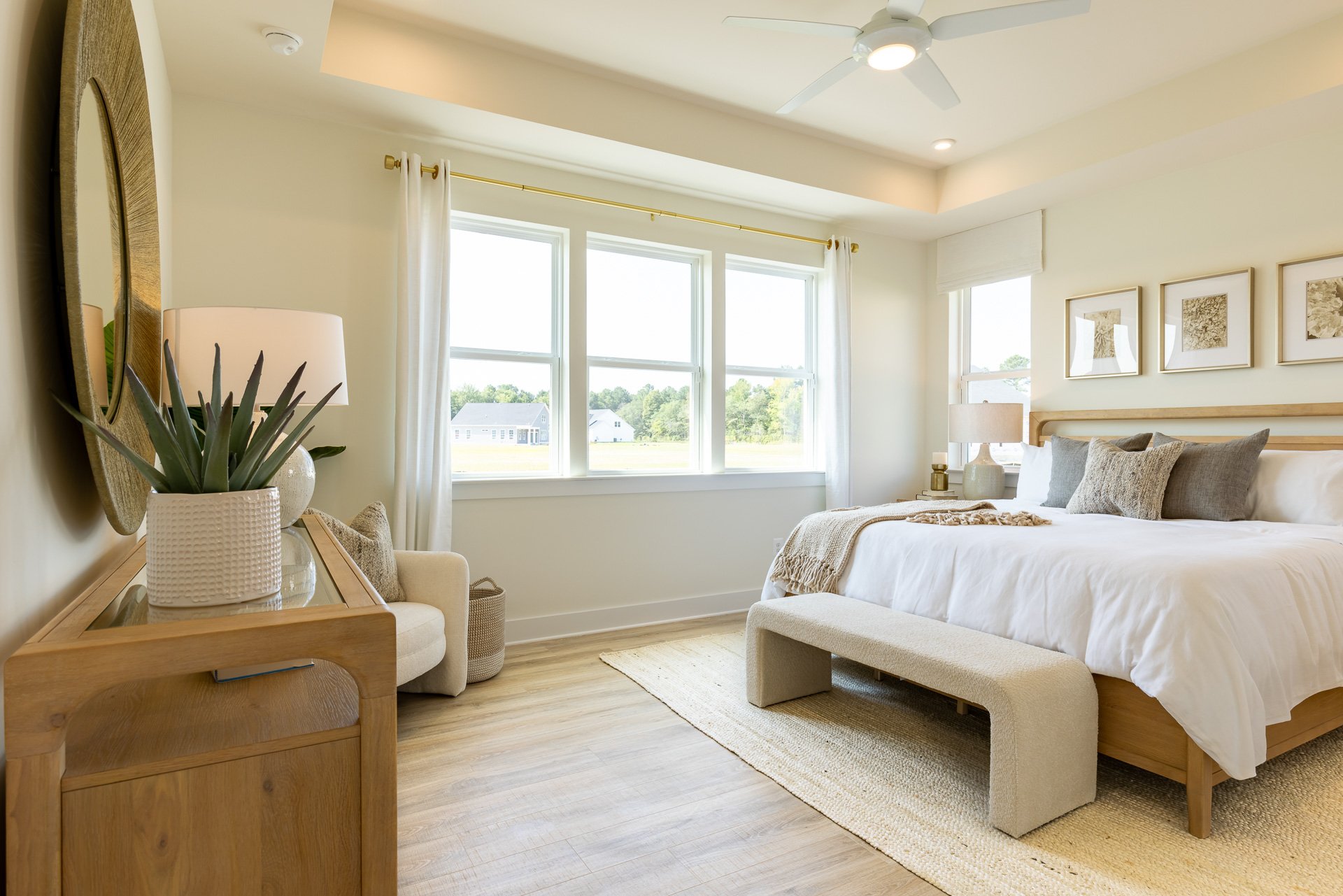 primary suite with a box ceiling and carpet