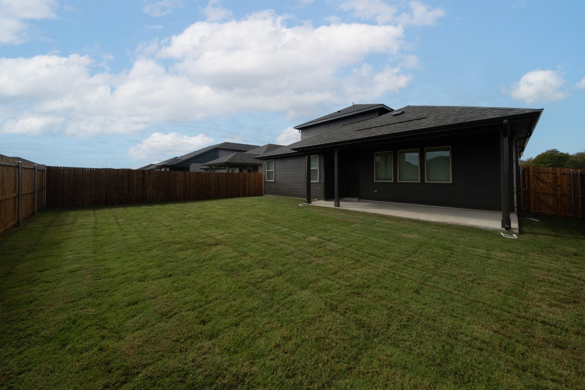 backyard with grass and covered patio