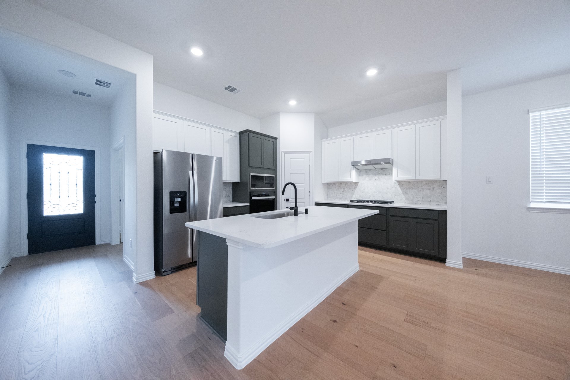 open kitchen with wood floors and island