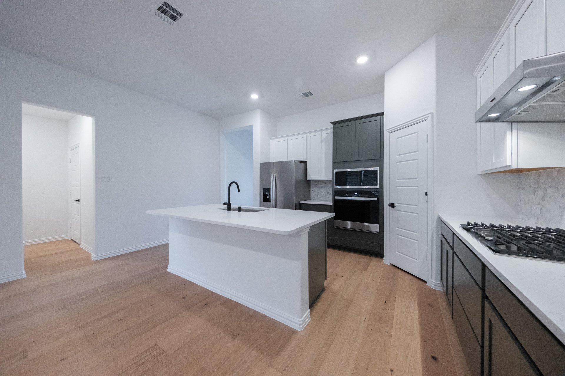 open kitchen with wood floors and island