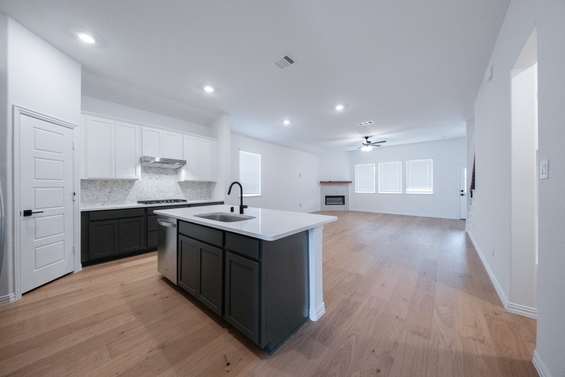 open kitchen with wood floors and island