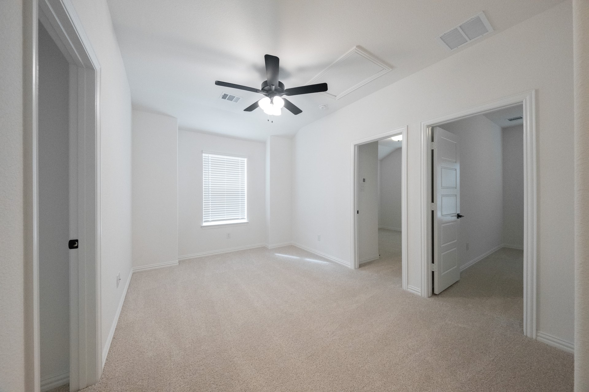 loft with carpet, ceiling fan, and window