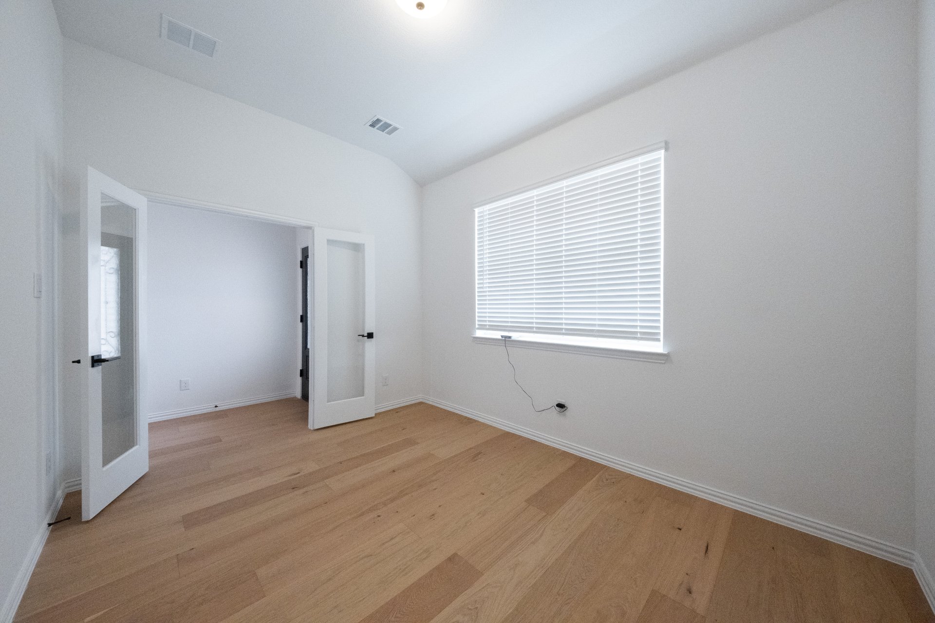 private study with wood floors and french doors