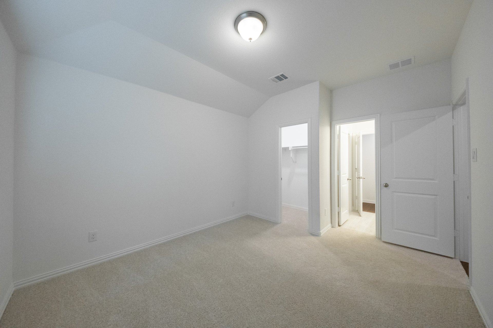 guest bedroom with carpet and walk-in closet