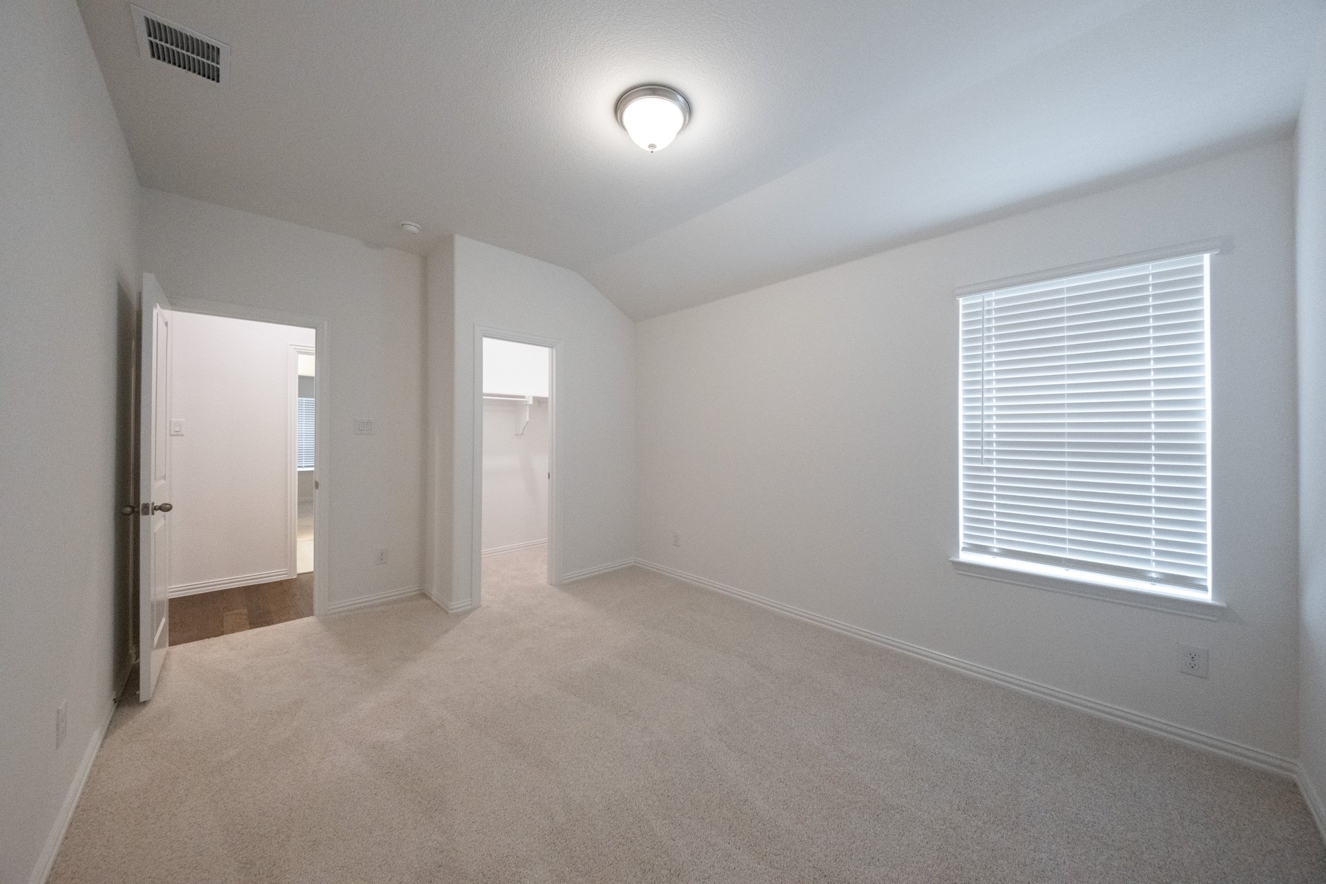 guest bedroom with carpet and walk-in closet