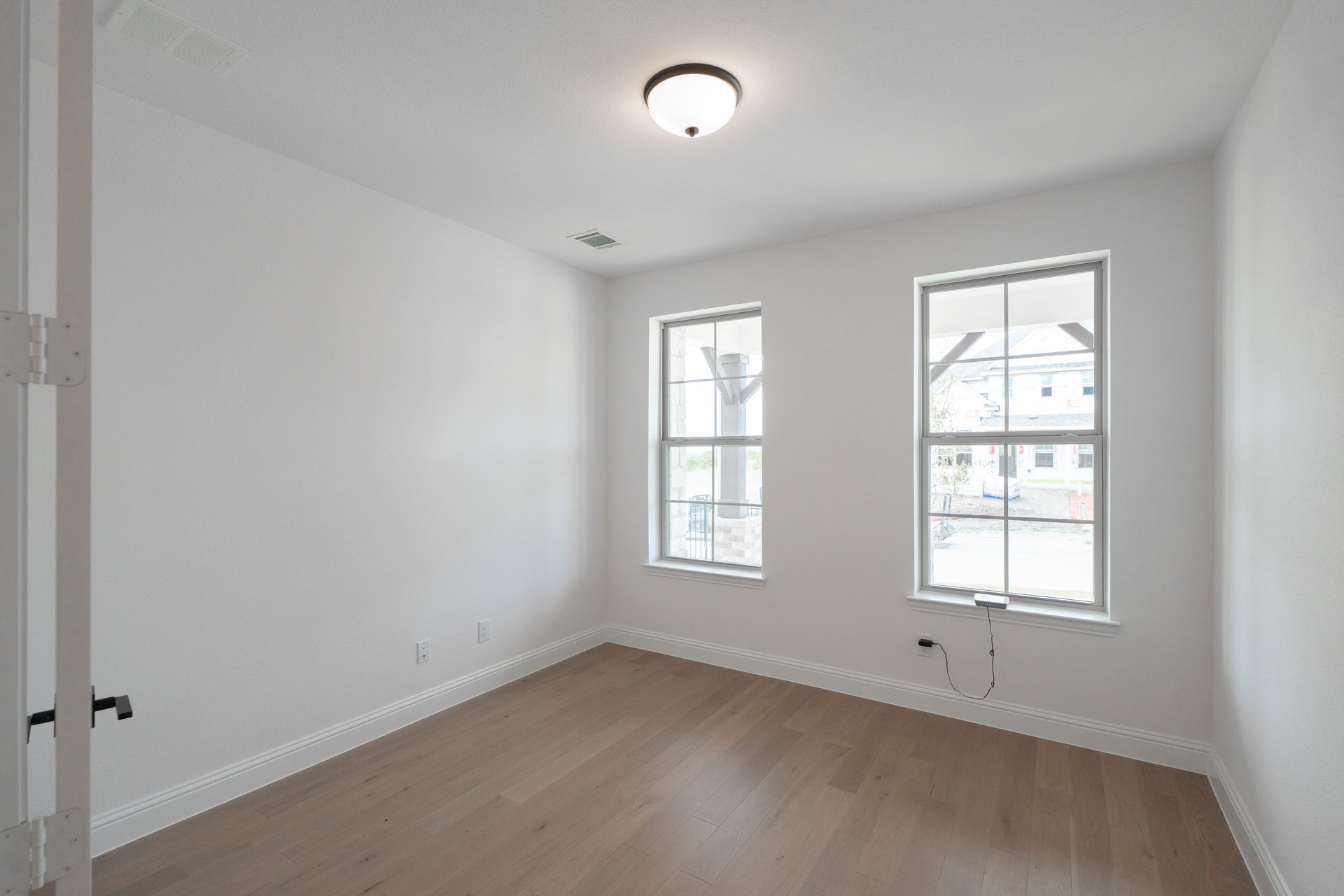 study with hardwood flooring and french doors