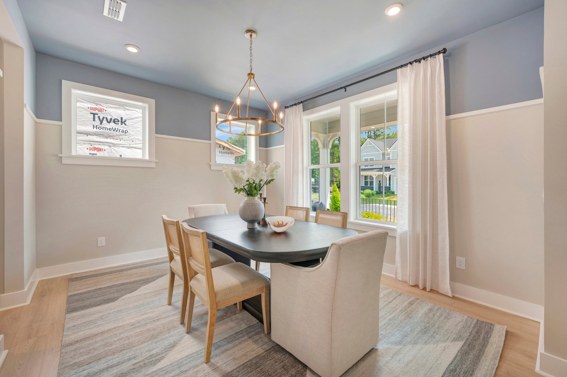 dining room with a rug and four windows