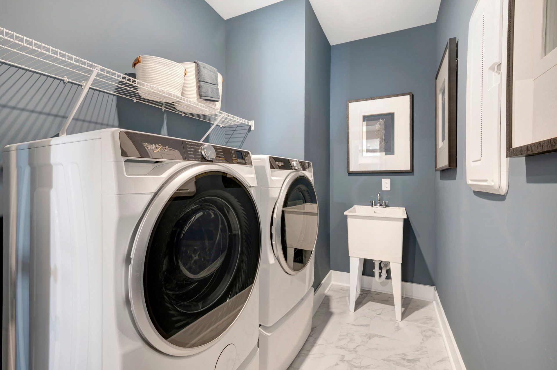 laundry room with wire shelves and a sink