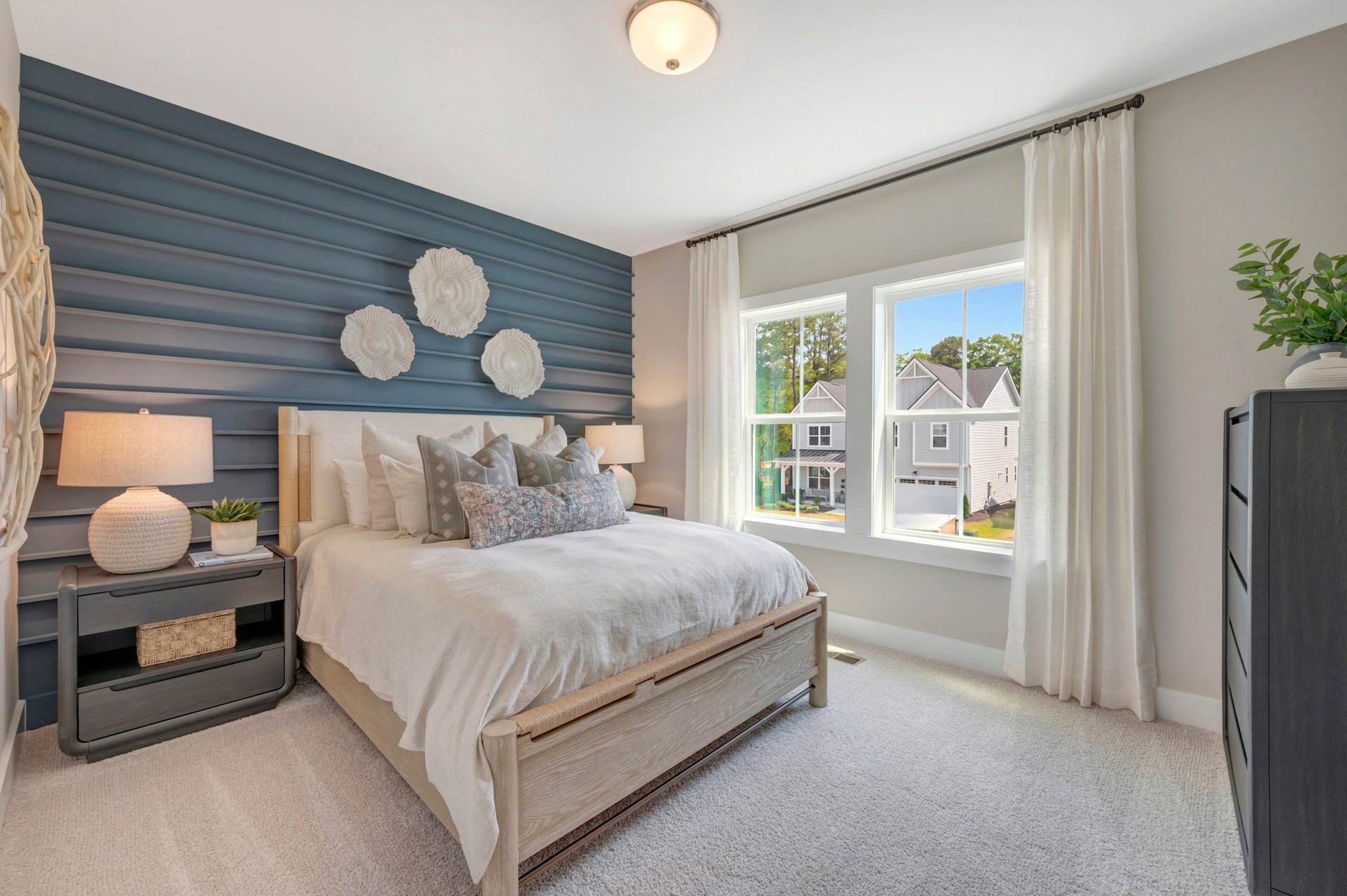 secondary bedroom with two windows and carpet