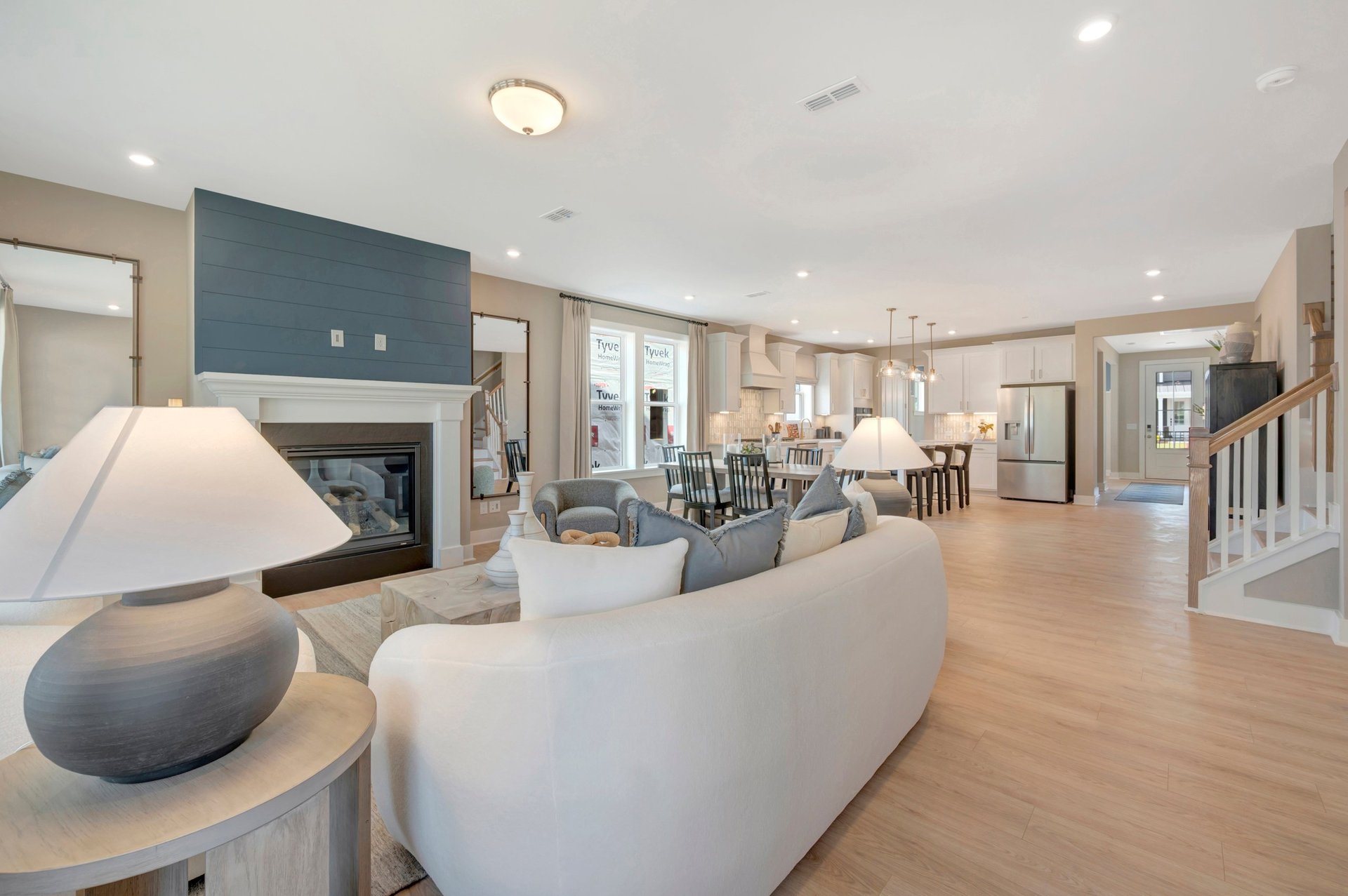 great room with a fireplace and access to kitchen