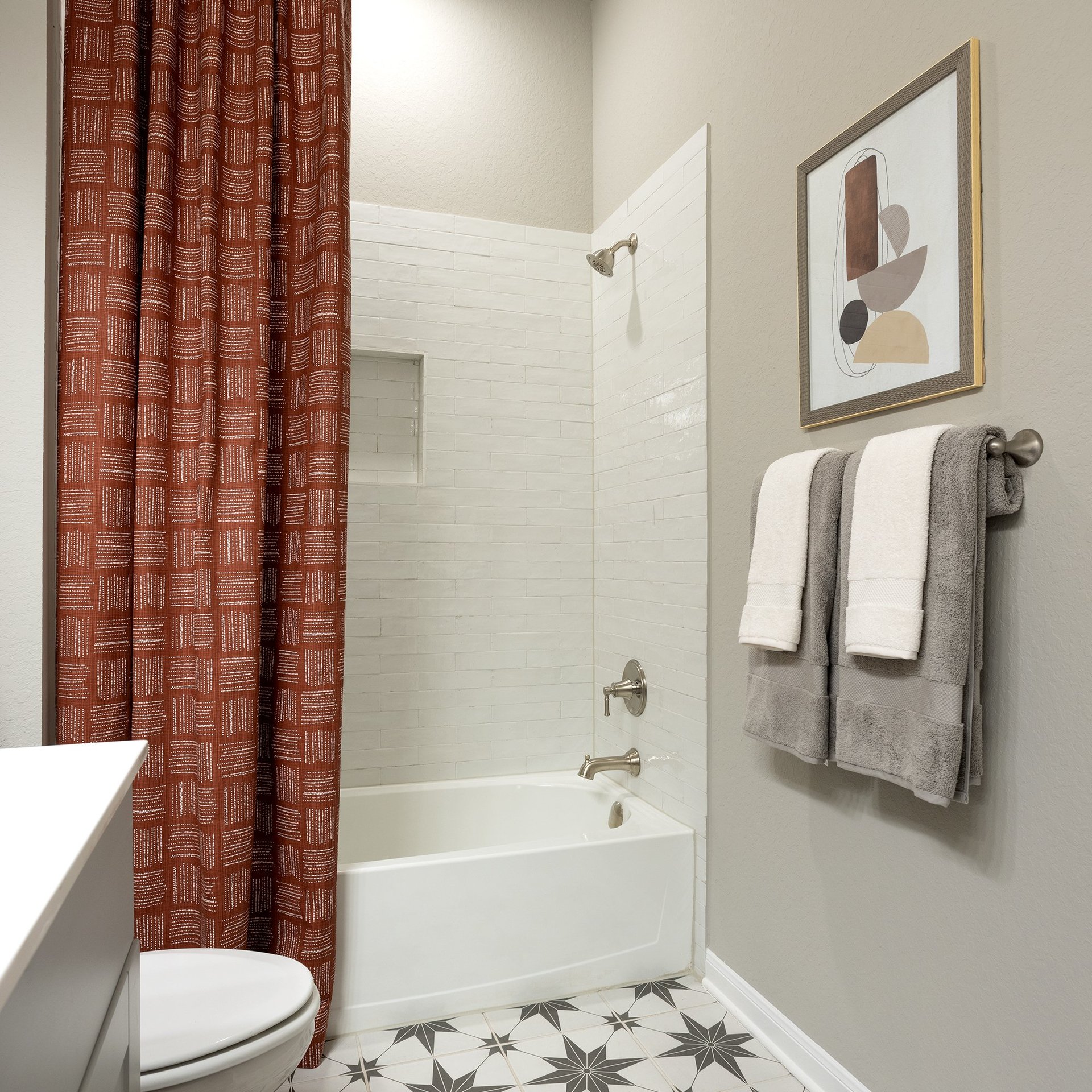 bathroom with quartz countertops & a tub with shower combo