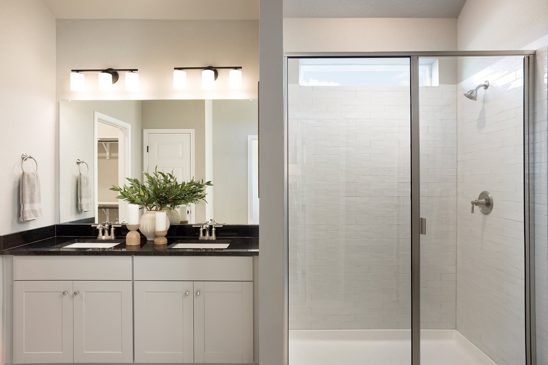 bathroom with dual sinks, quartz countertops & walk-in shower