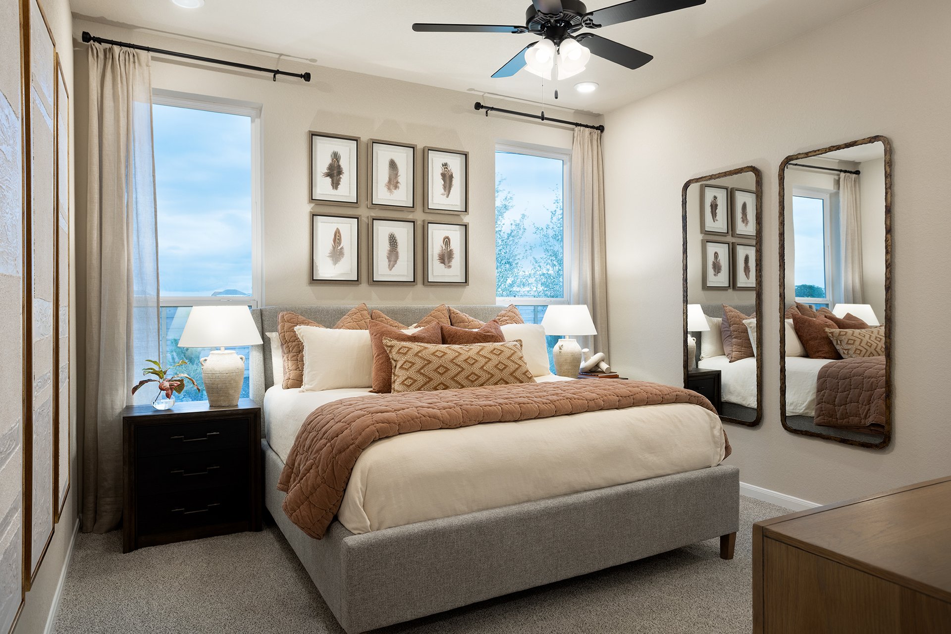 bedroom with carpet, windows & a ceiling fan