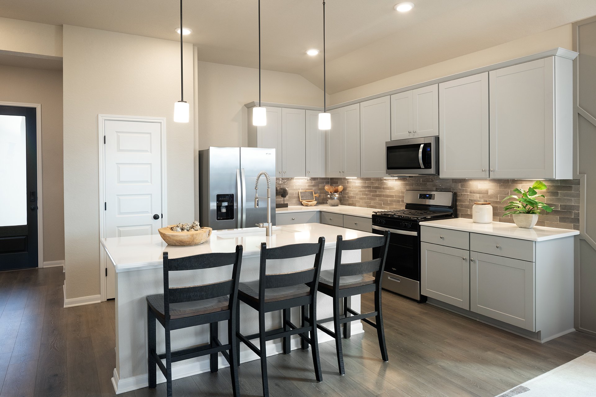 kitchen with brown flooring, gray cabinets & white countertops