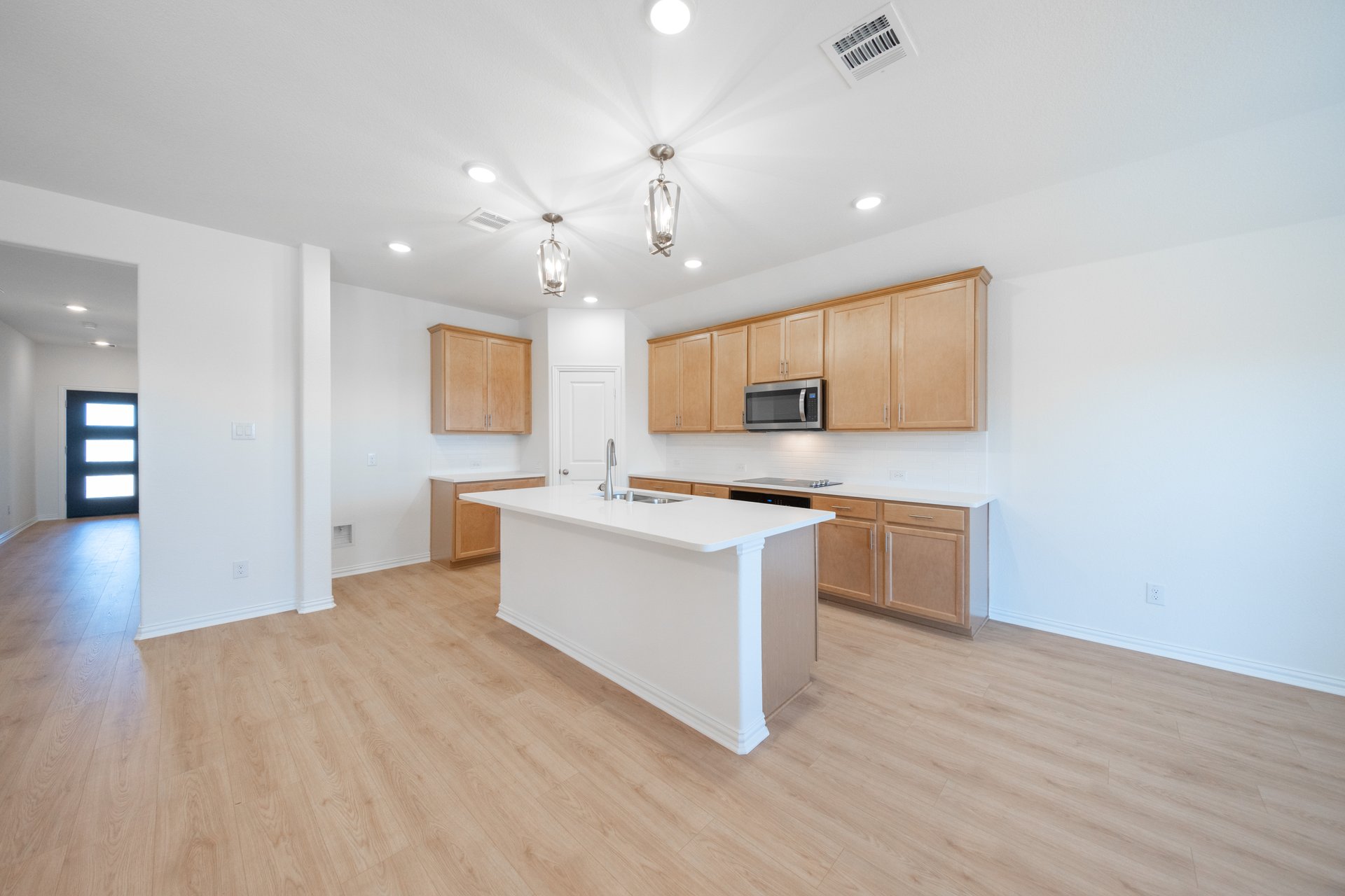 open kitchen with brown wood cabinets