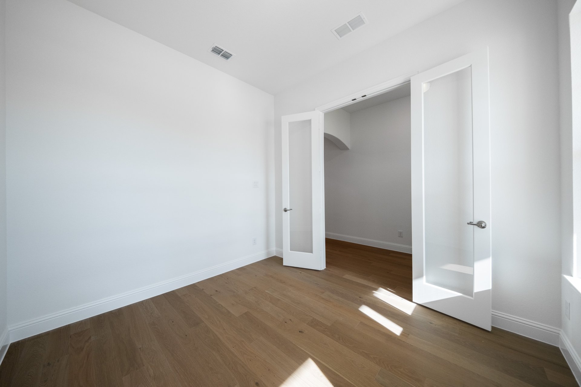 study with wood flooring and french doors 