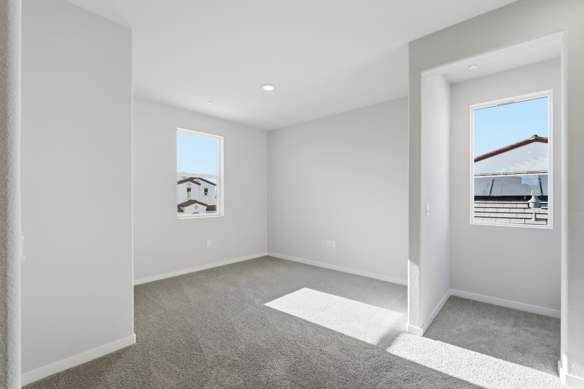 loft with gray carpet, window, and recessed ceiling light