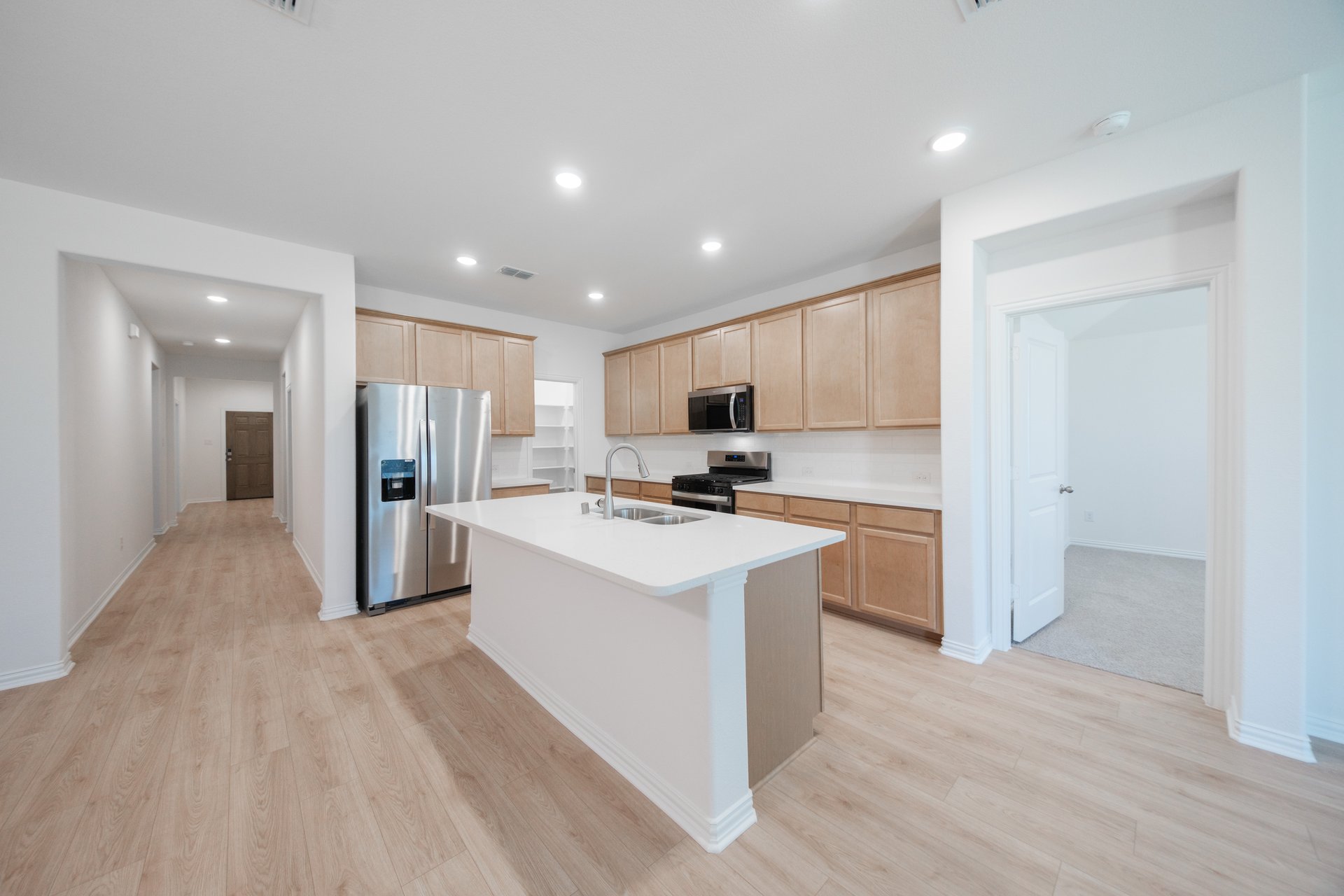 open kitchen with wood floors and island