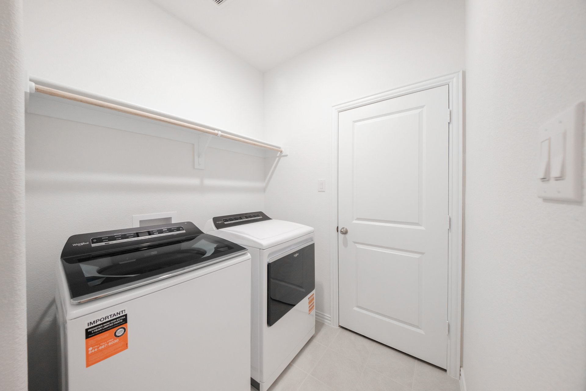 laundry room with tile floors, washer, and dryer