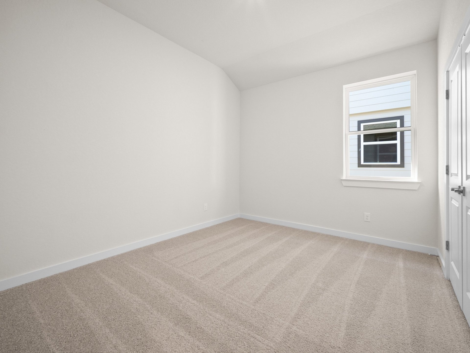 bedroom with carpet, window & a sloped ceiling