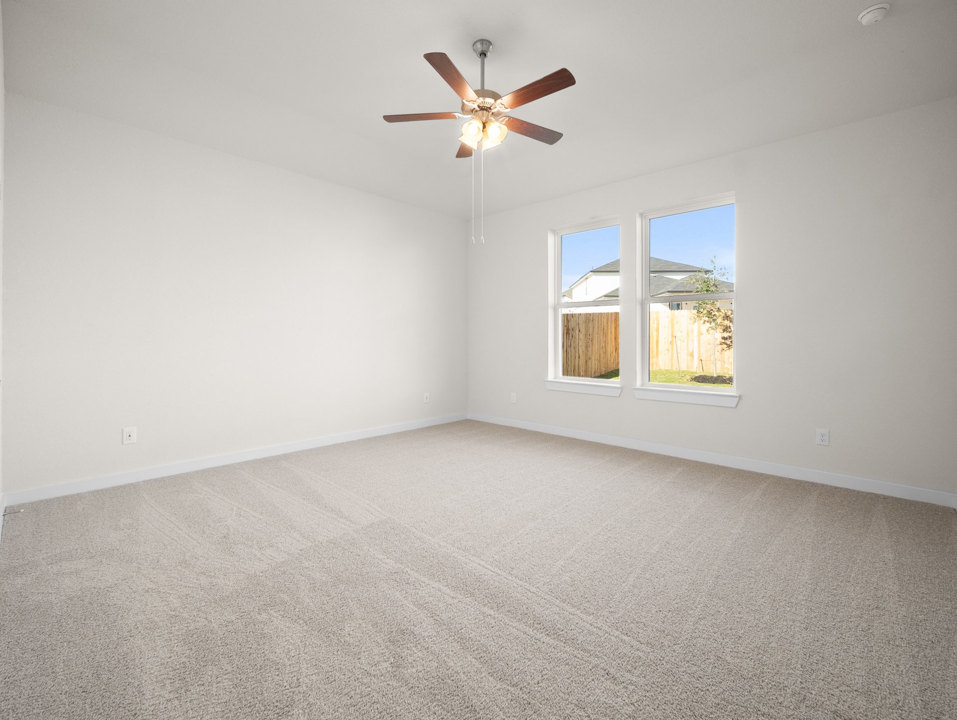 bedroom with carpet, ceiling fan & windows