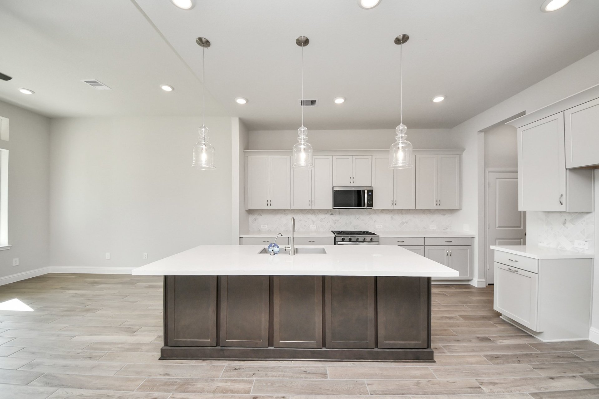 large kitchen island with sink and pendant lights