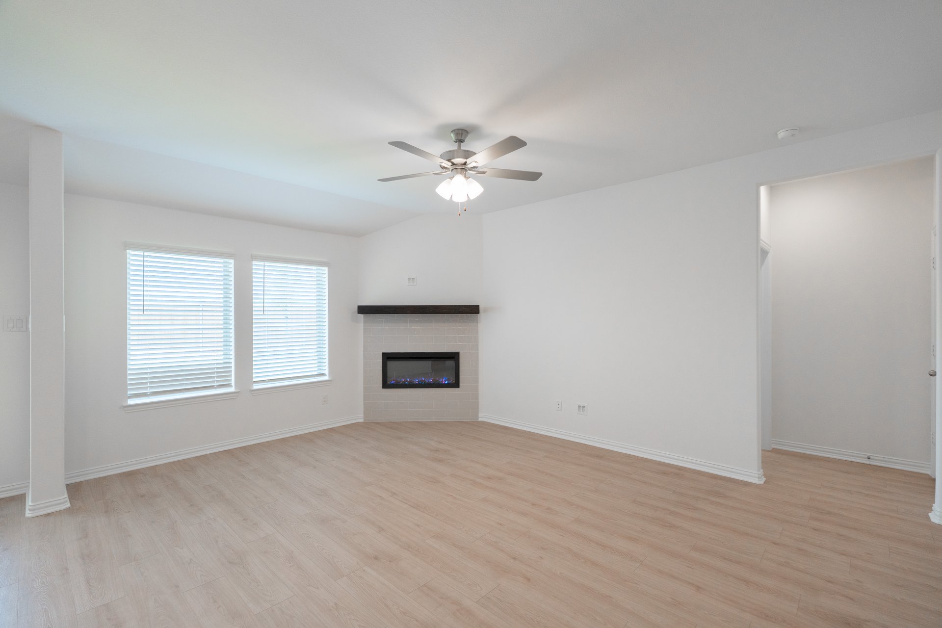 open great room with wood floors and fireplace