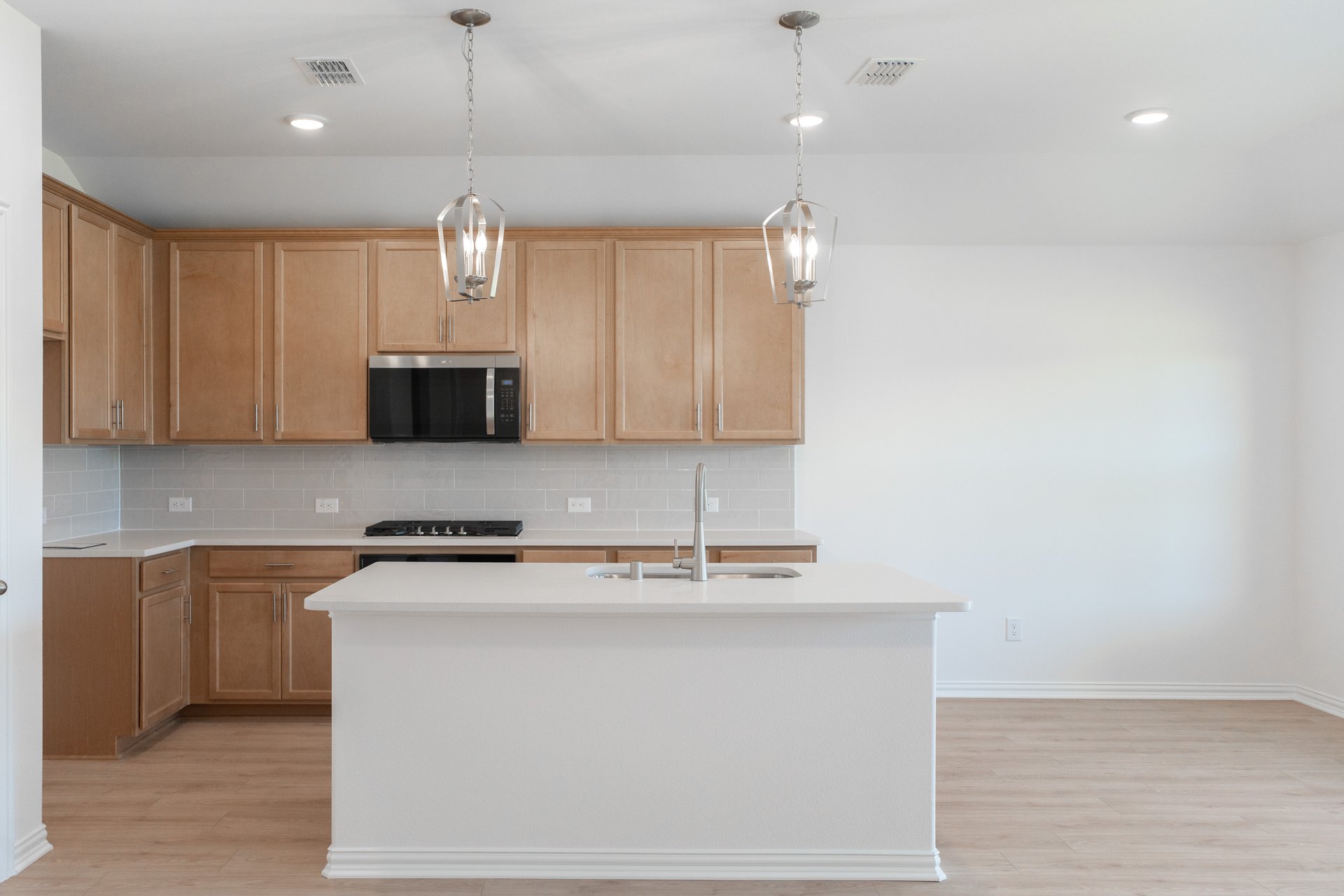 open kitchen with wood floors and island