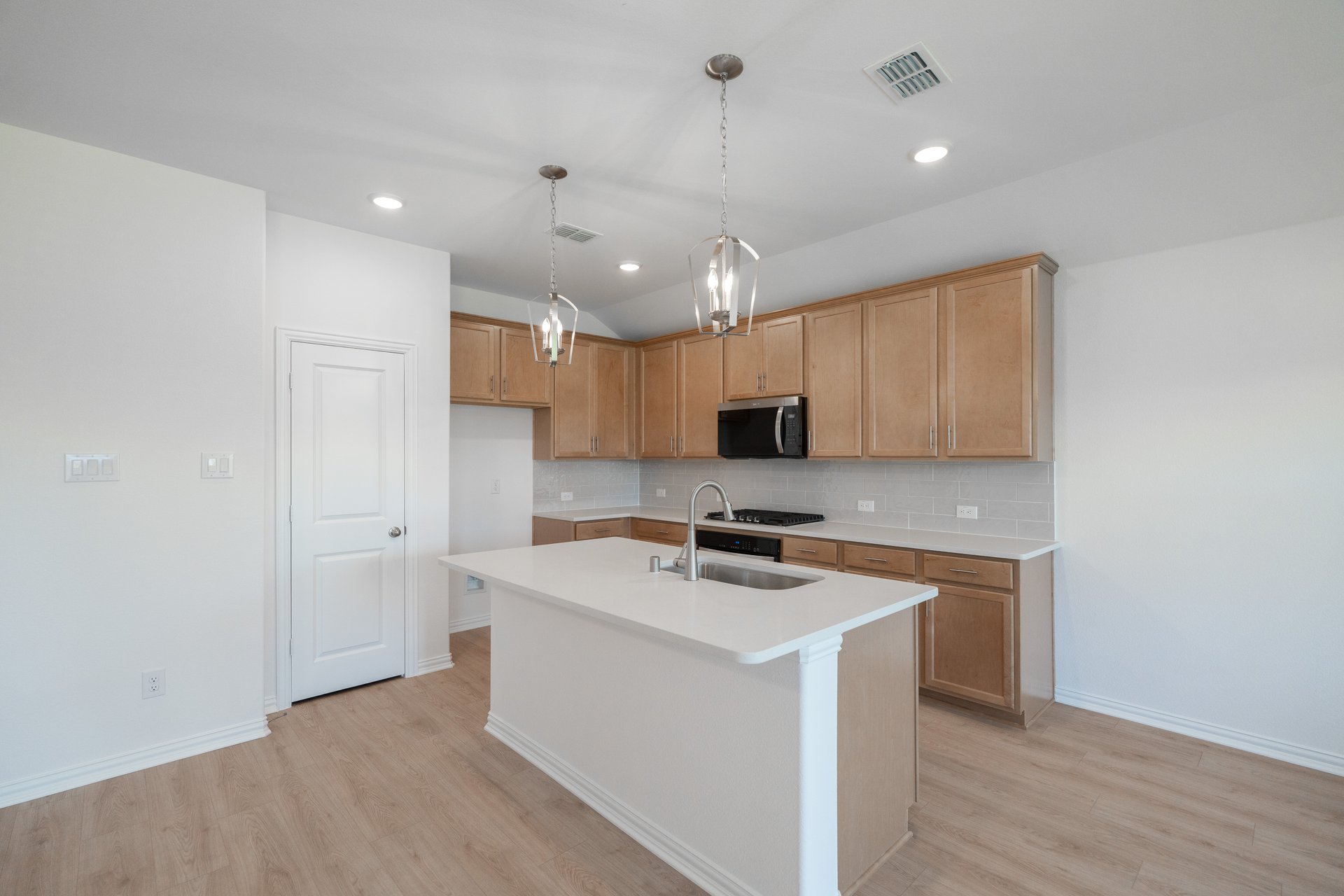 open kitchen with wood floors and island