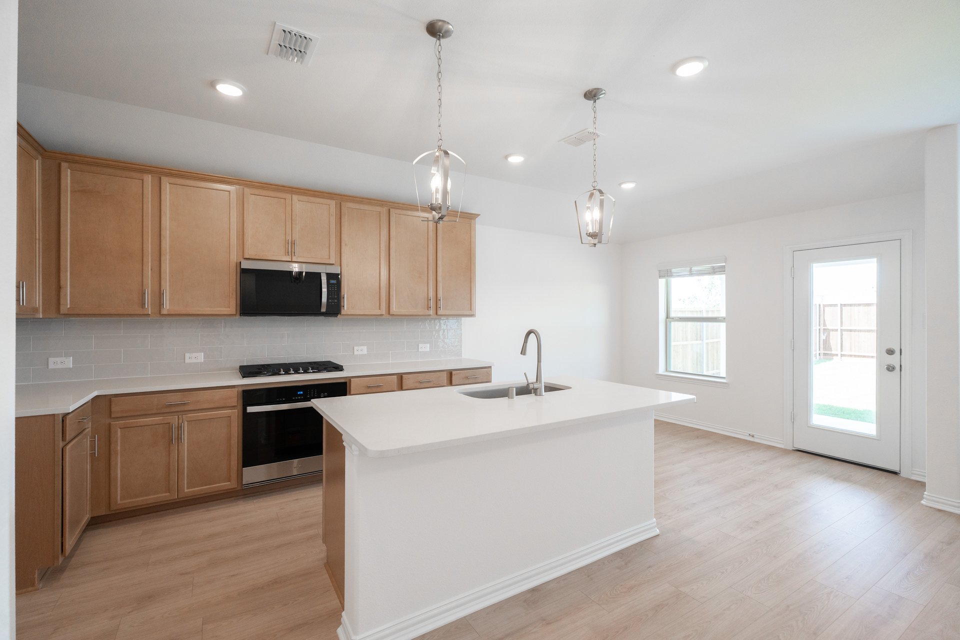 open kitchen with wood floors and island