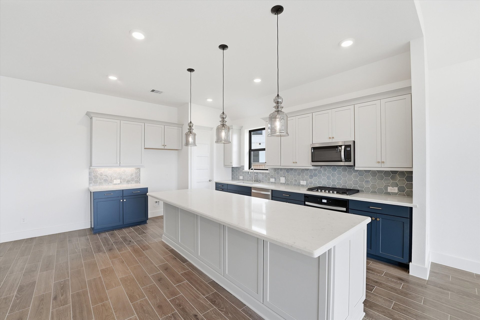 open kitchen with white cabinets and hardwood flooring