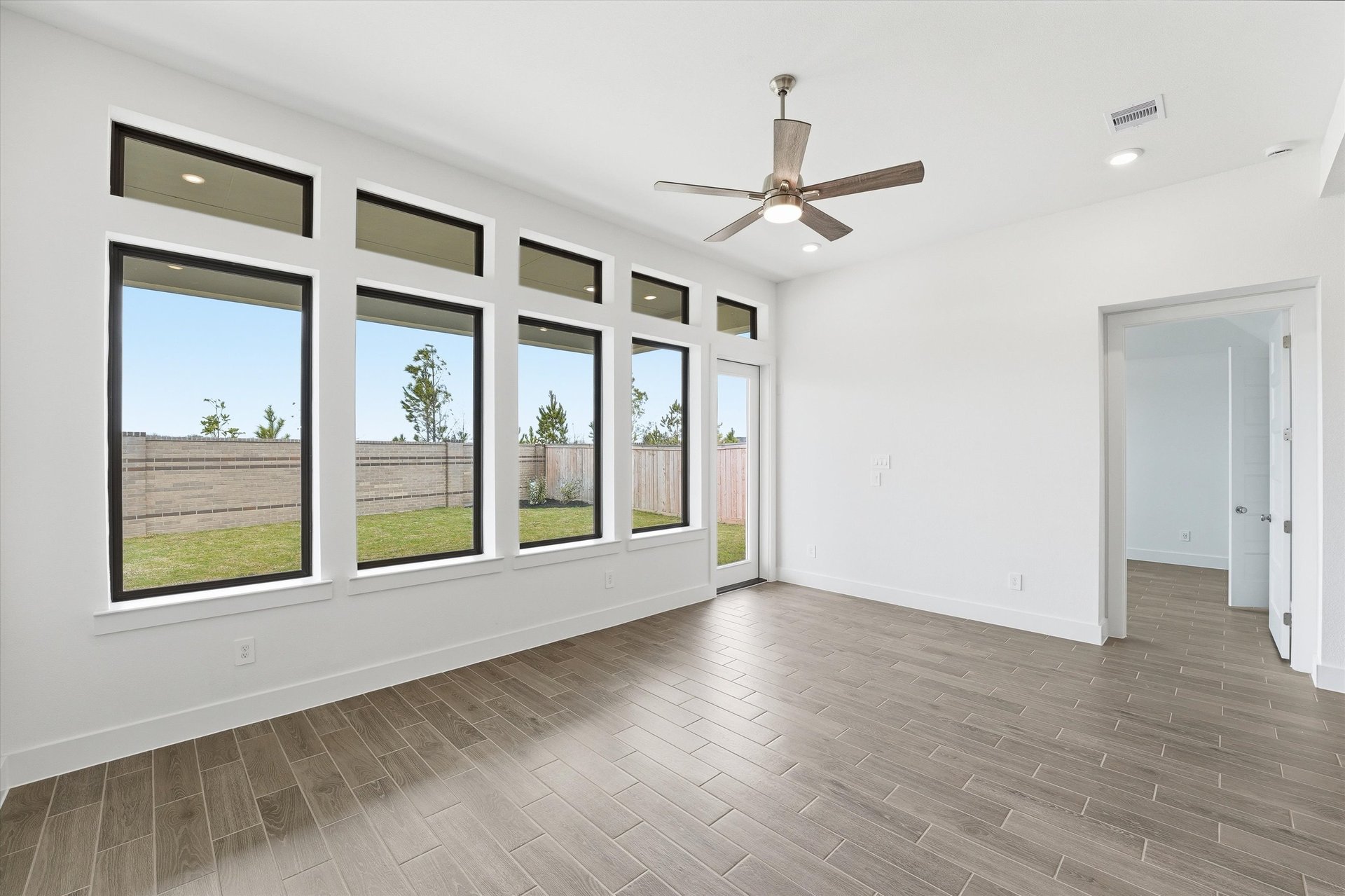 open great room with windows and hardwood flooring