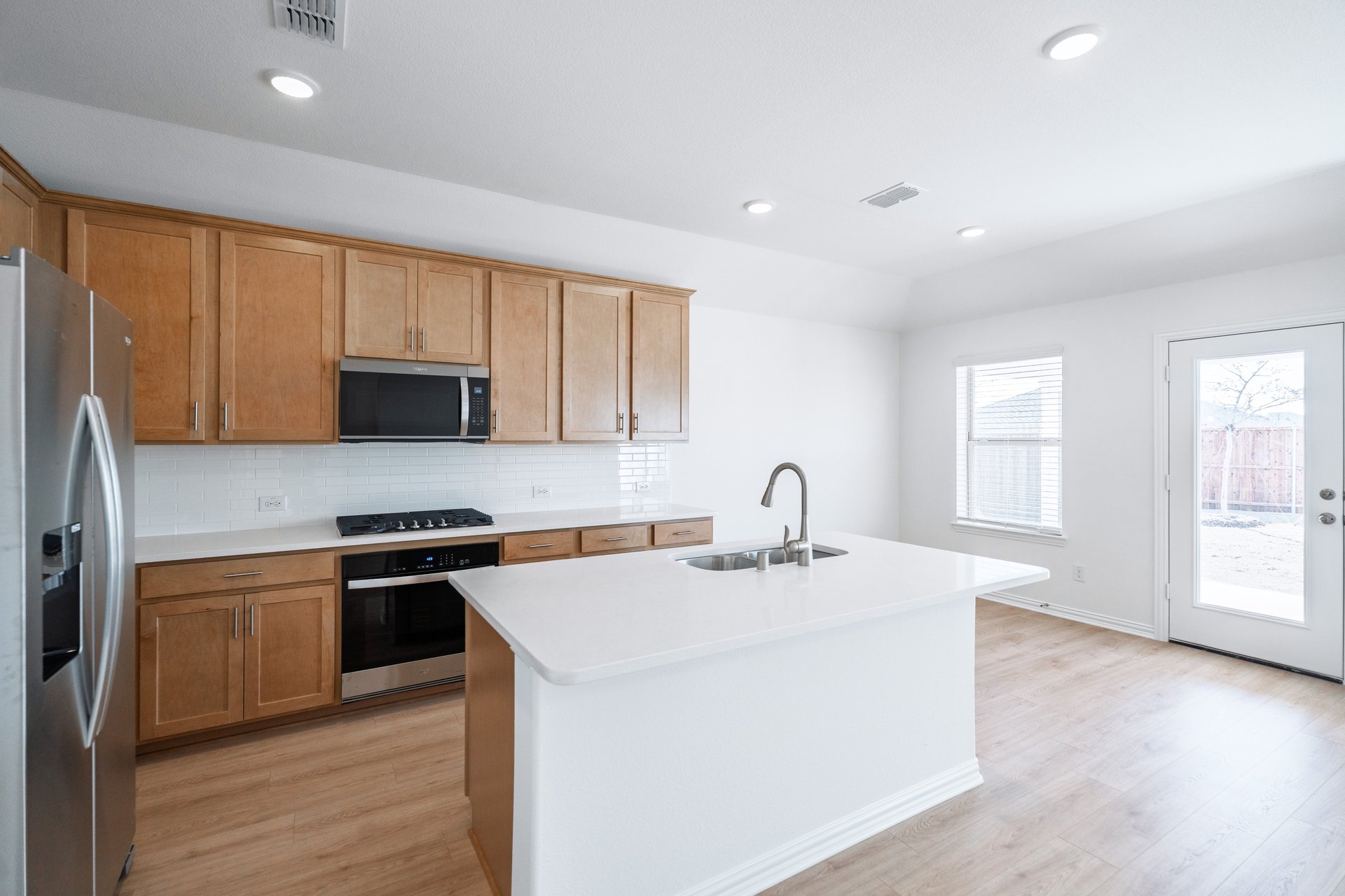 kitchen with open concept and brown cabinets