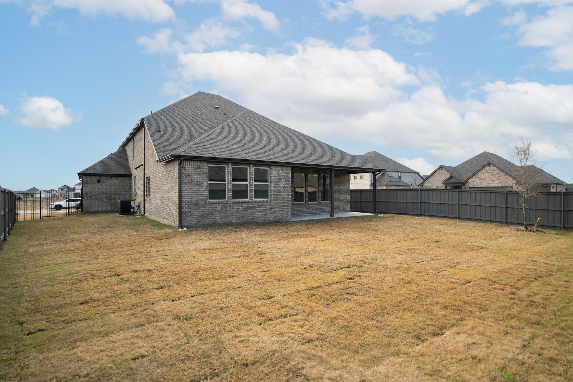 backyard of home with grey fence