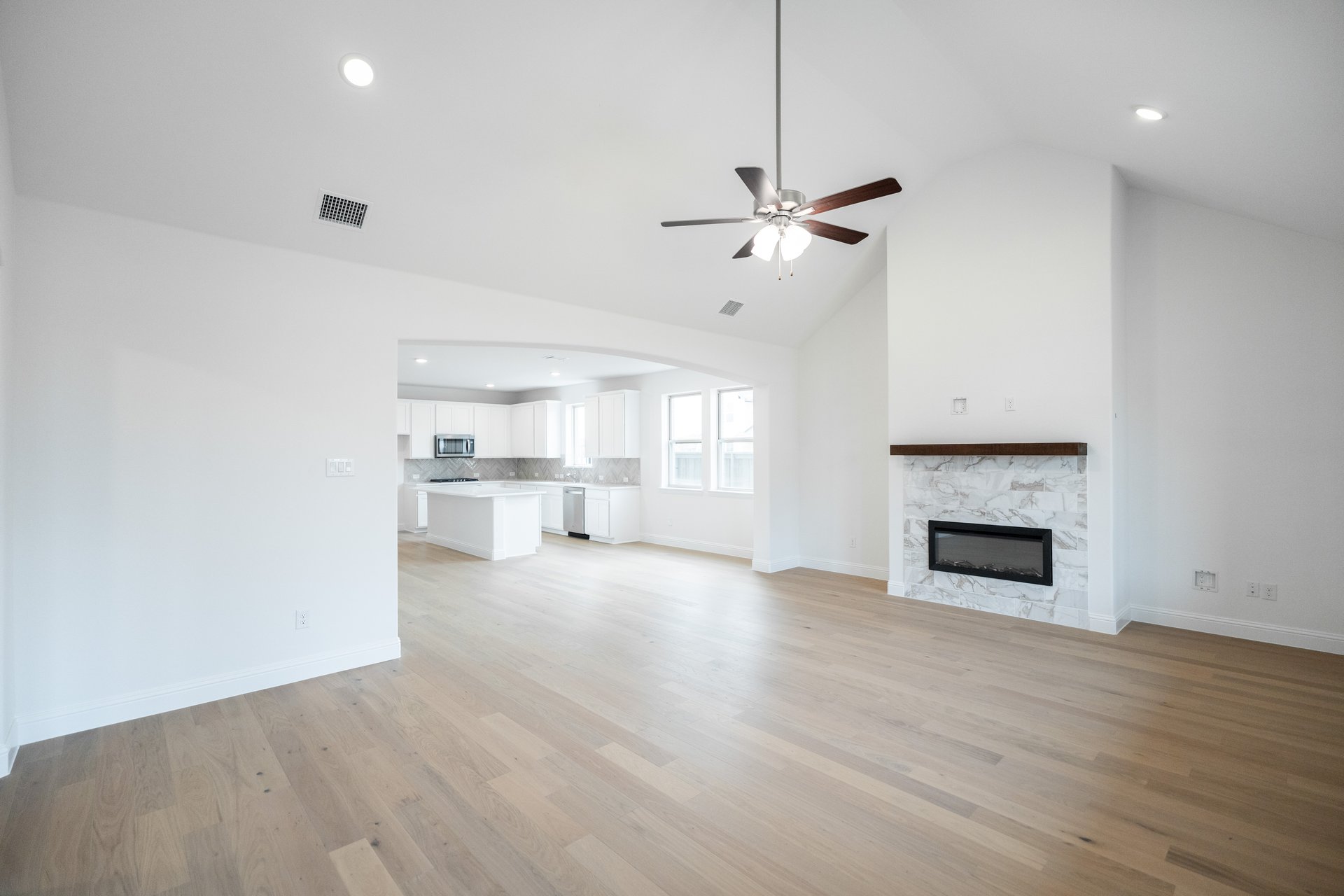 great room with fireplace and hard wood flooring