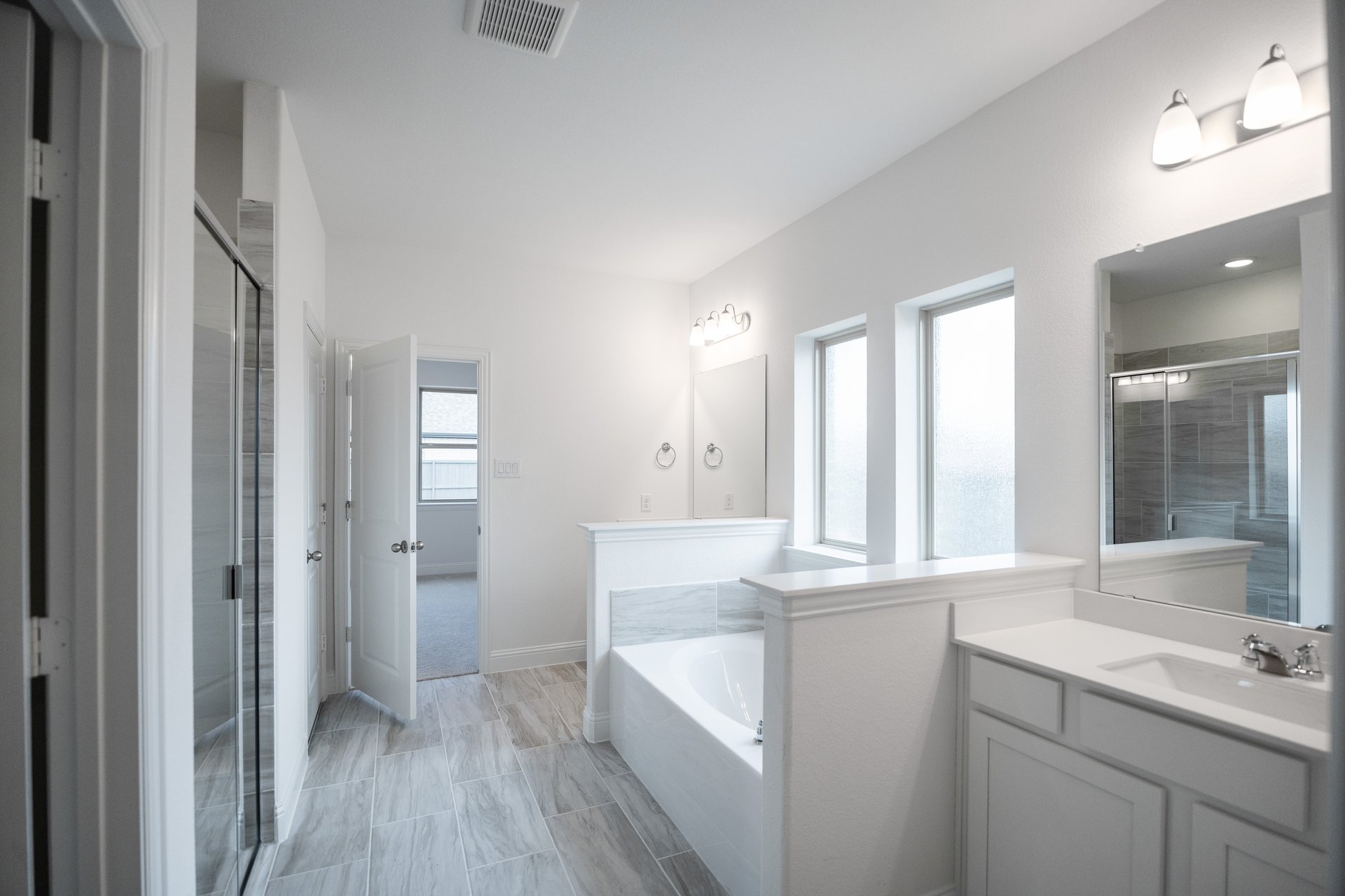 primary bathroom with tub and stand-up shower