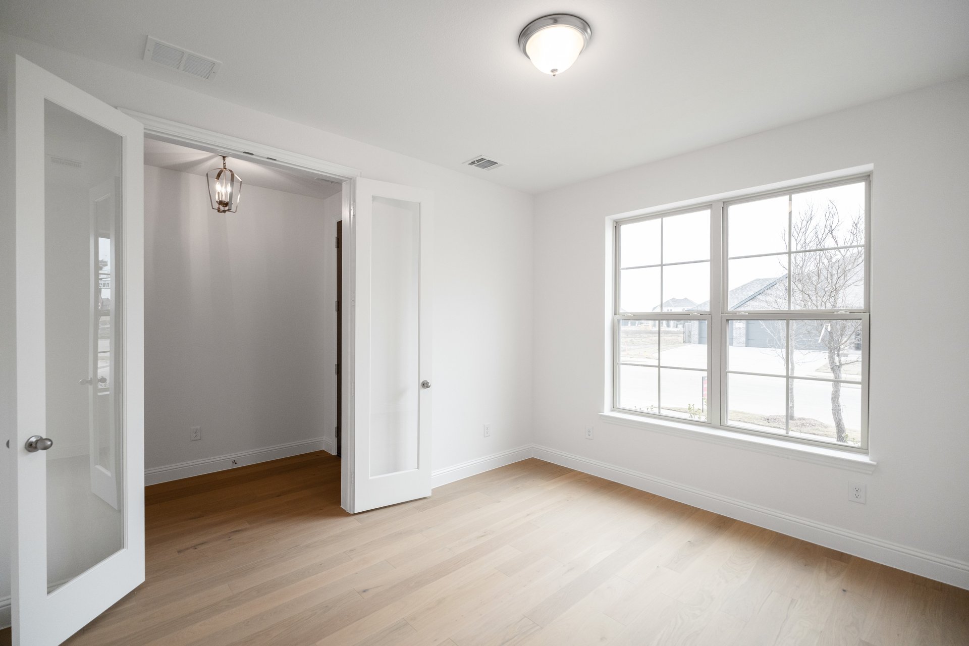 study room with french doors and hard wood flooring