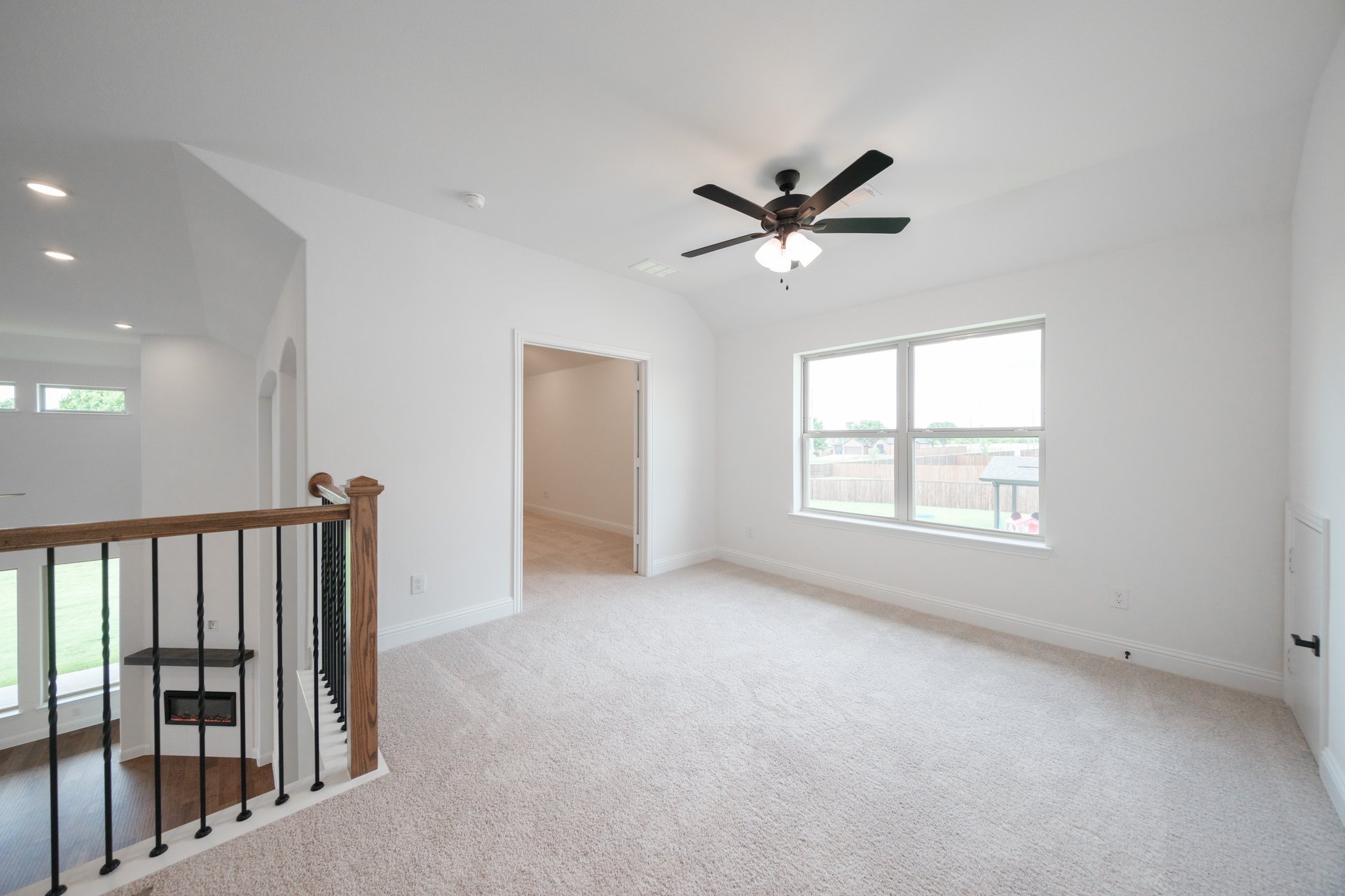 open gameroom with carpet and ceiling fan