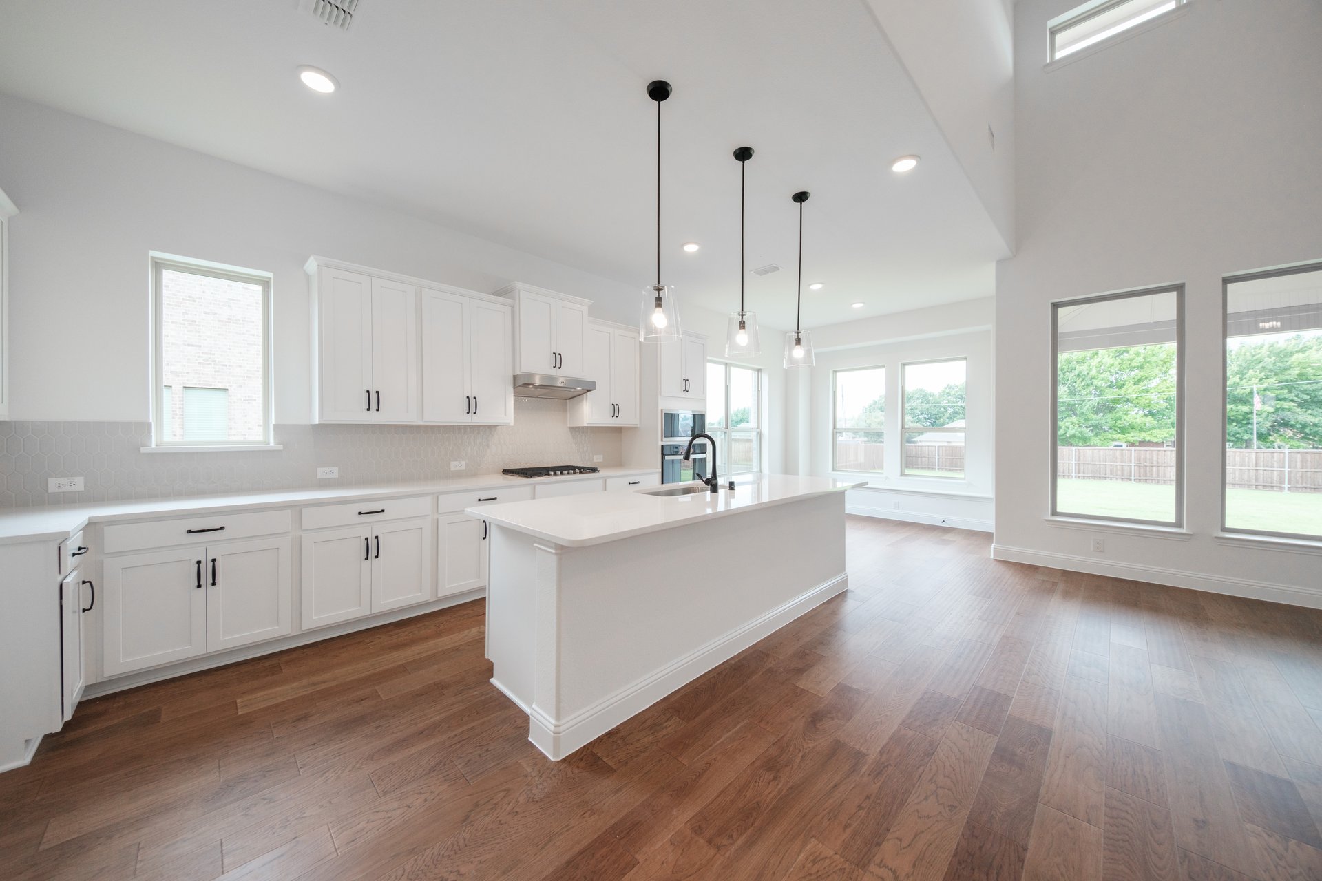 open kitchen with wood floors and island
