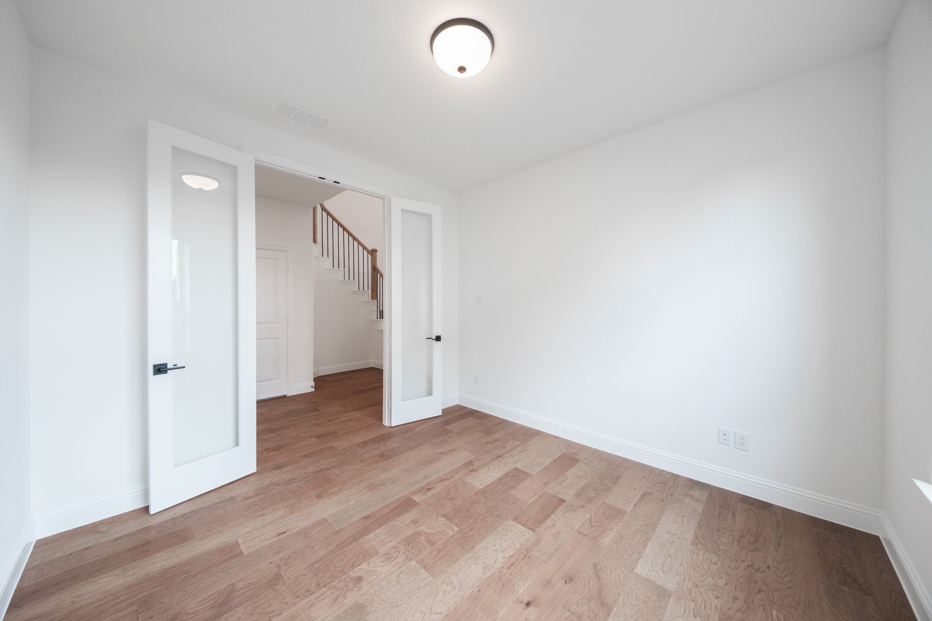 private study with wood floors and french doors