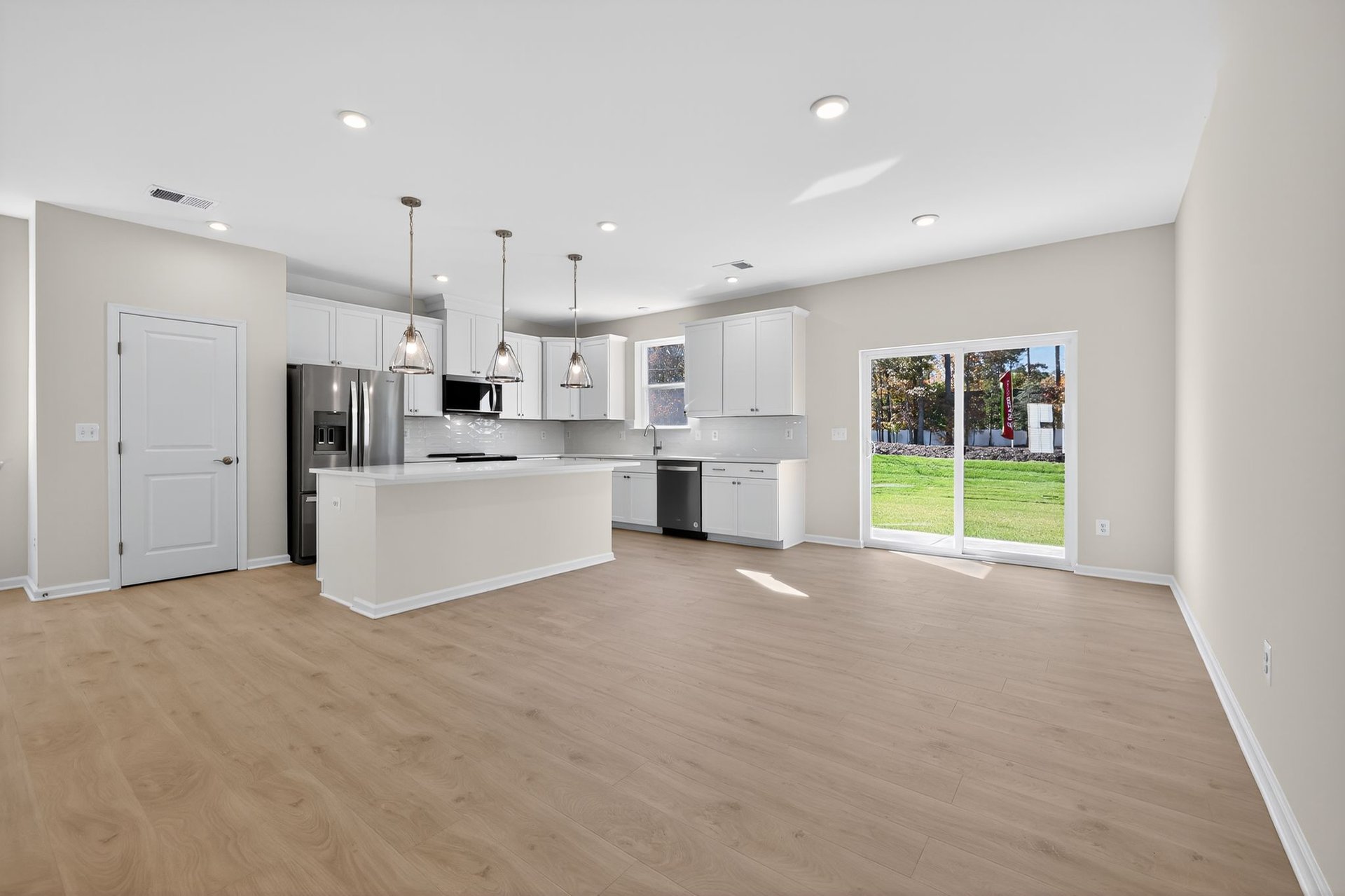 dining area and kitchen connect with designer flooring