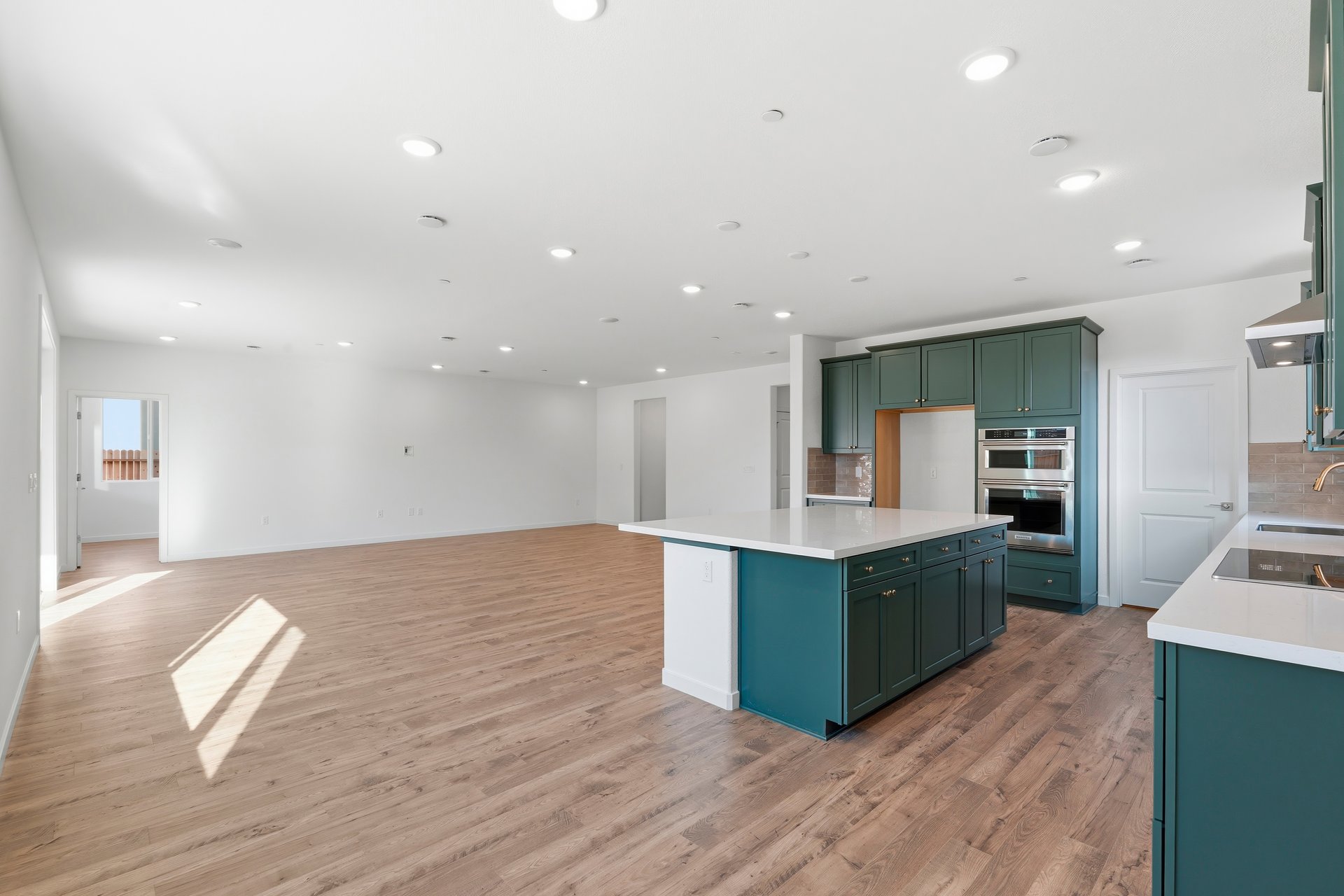dining room with wood floors, white walls, and view of kitchen & great room
