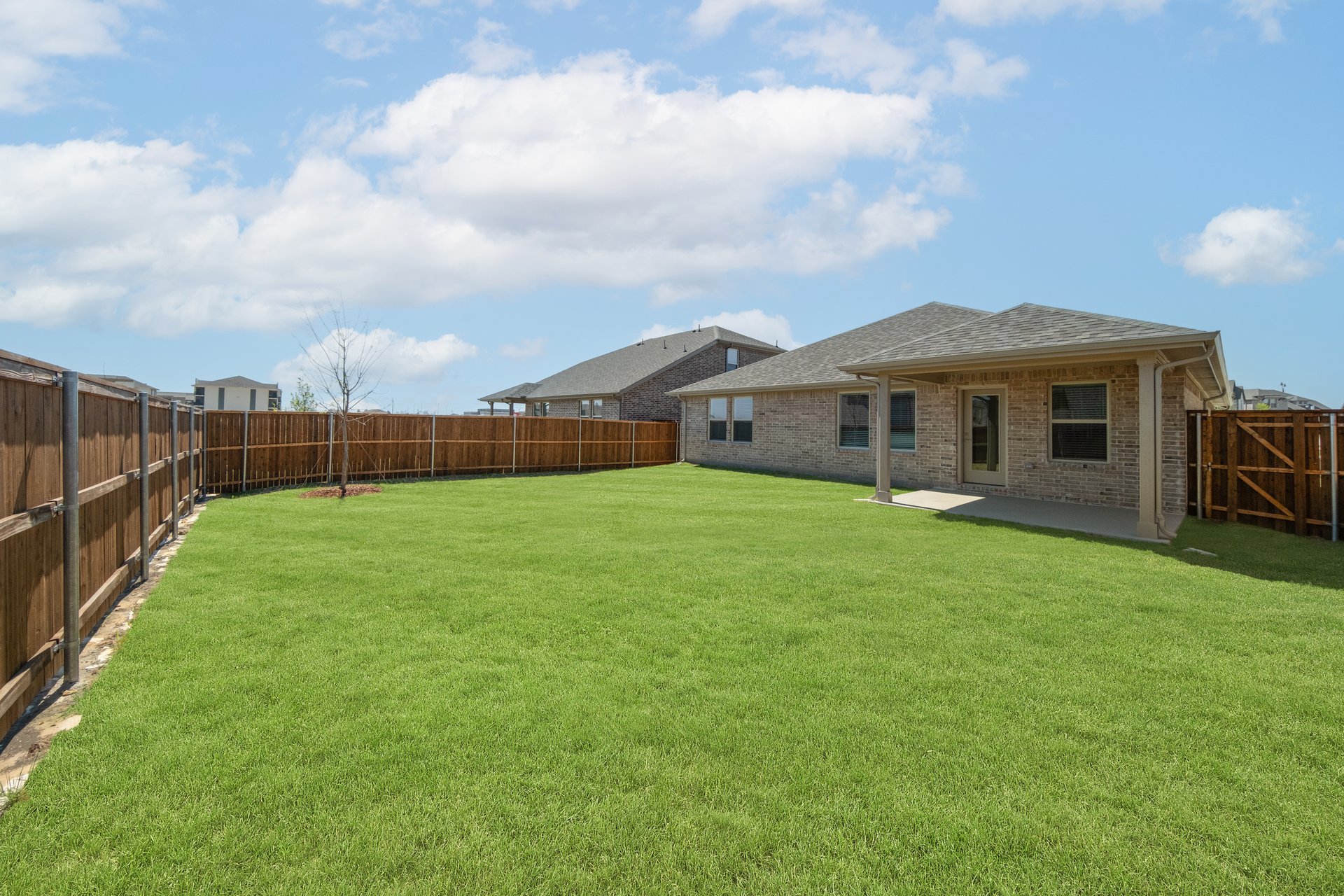 backyard with grass and covered patio