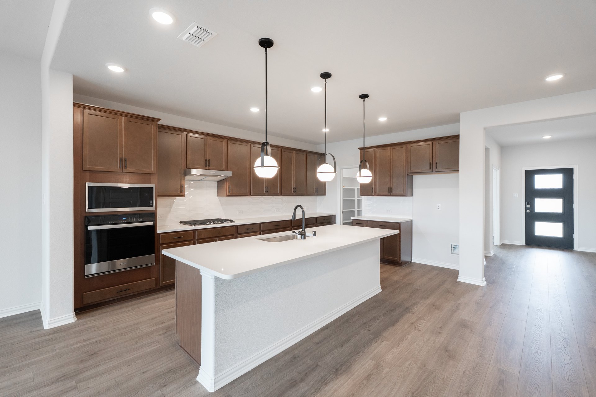 open kitchen with wood floors and island