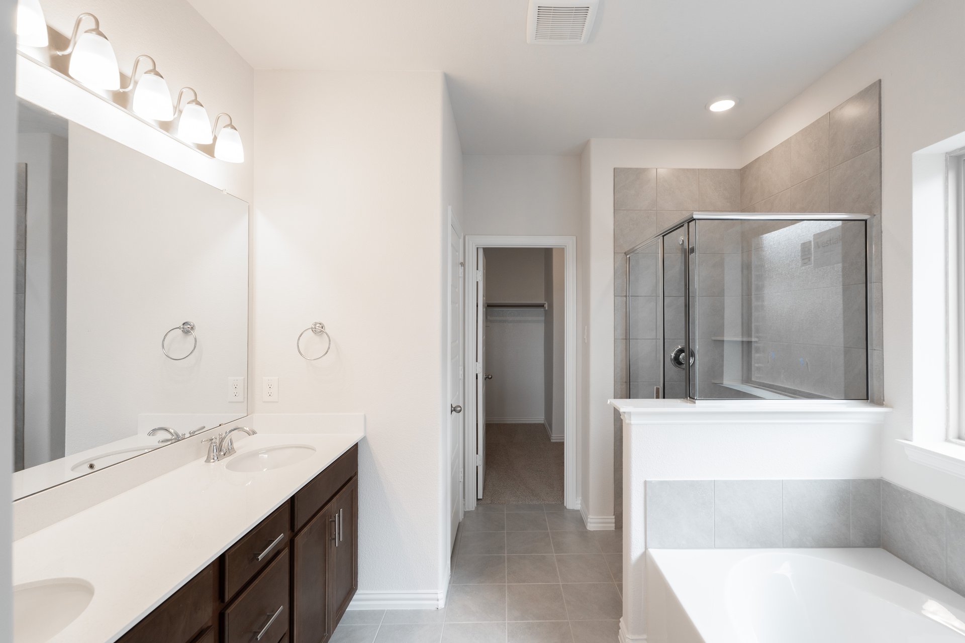 primary bathroom with soaking tub and walk-in shower